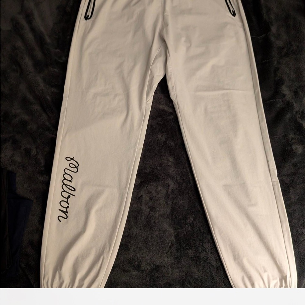 Cream colored malbon joggers with Black Script Logo